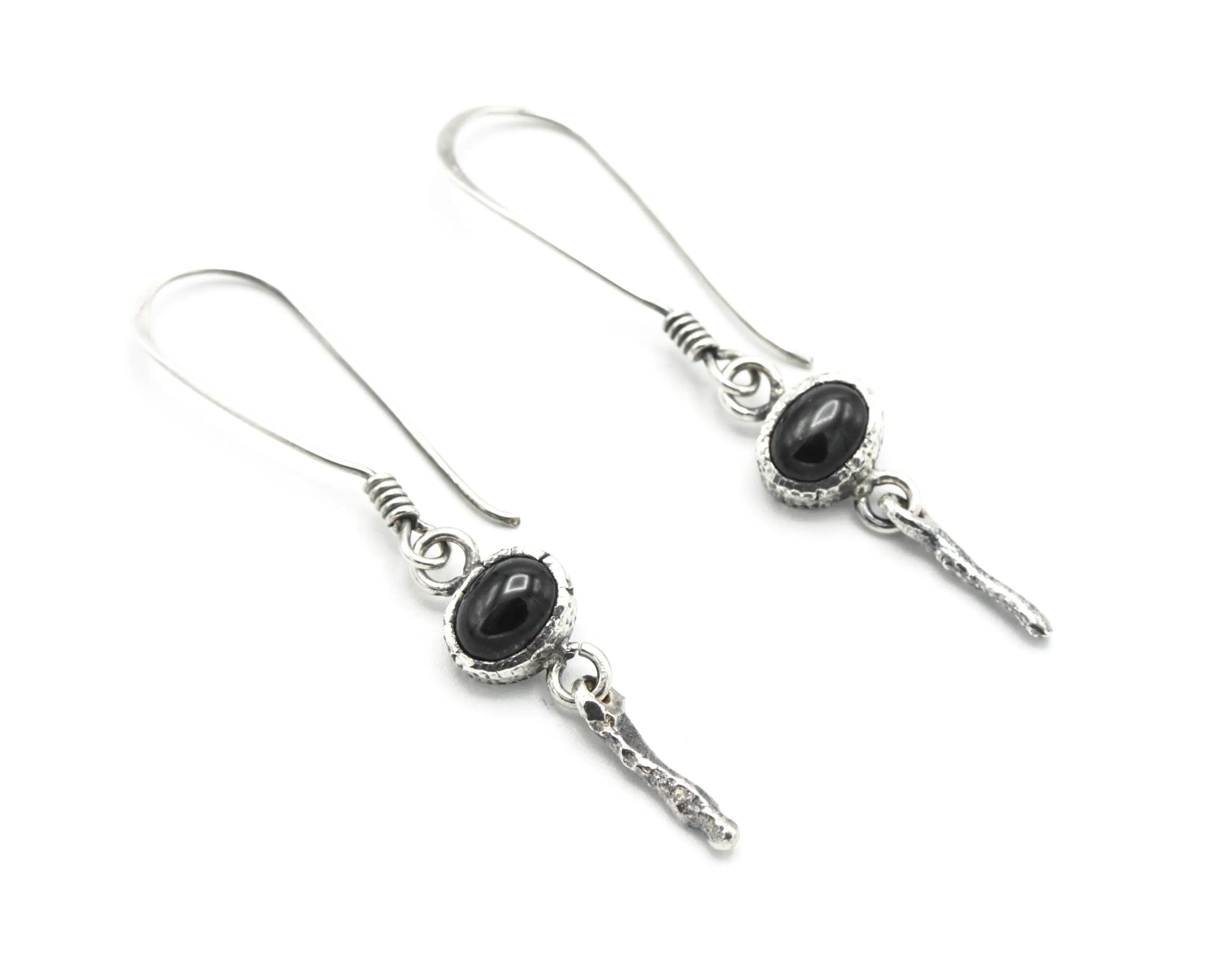 Oval Star Diopside Earrings, featuring a silver bezel setting and silver sticks and hooks on the top